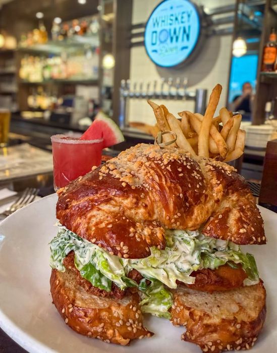 Chicken Caesar sando plated at the bar