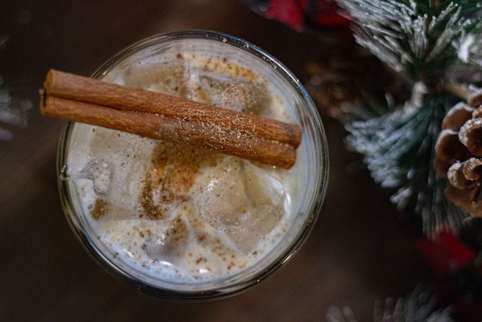 A cinnamon cocktail beside the tree