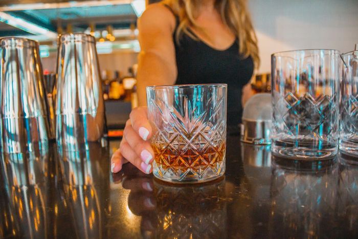 A cocktail set down on the bar