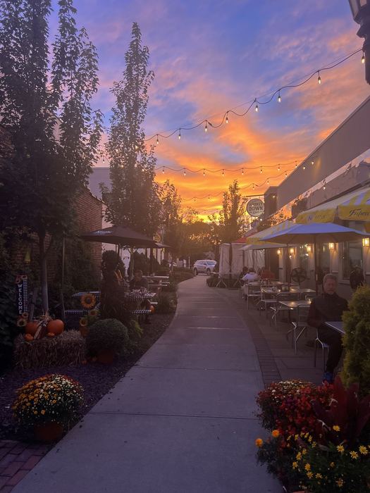 The courtyard under string lights at sunset