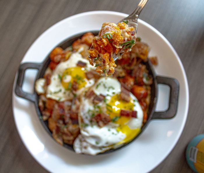 Eggs baked over hash in a skillet