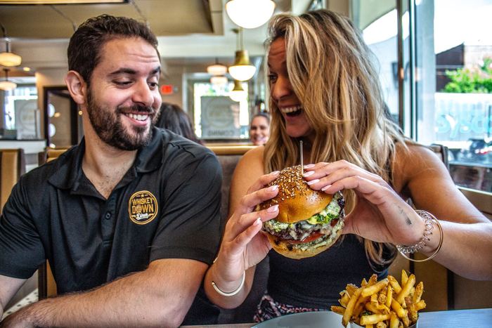 Two guests sharing a burger and fries