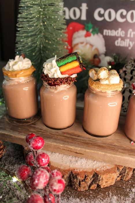 A flight of hot cocoas with different toppings