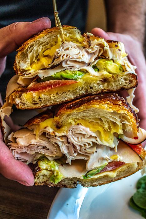 Turkey club stacked on a pretzel croissant